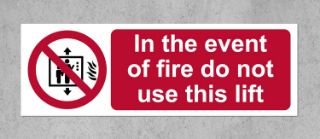 Picture of In the event of fire do not use this lift Safety sign - Self adhesive sticker 150mm x 50mm